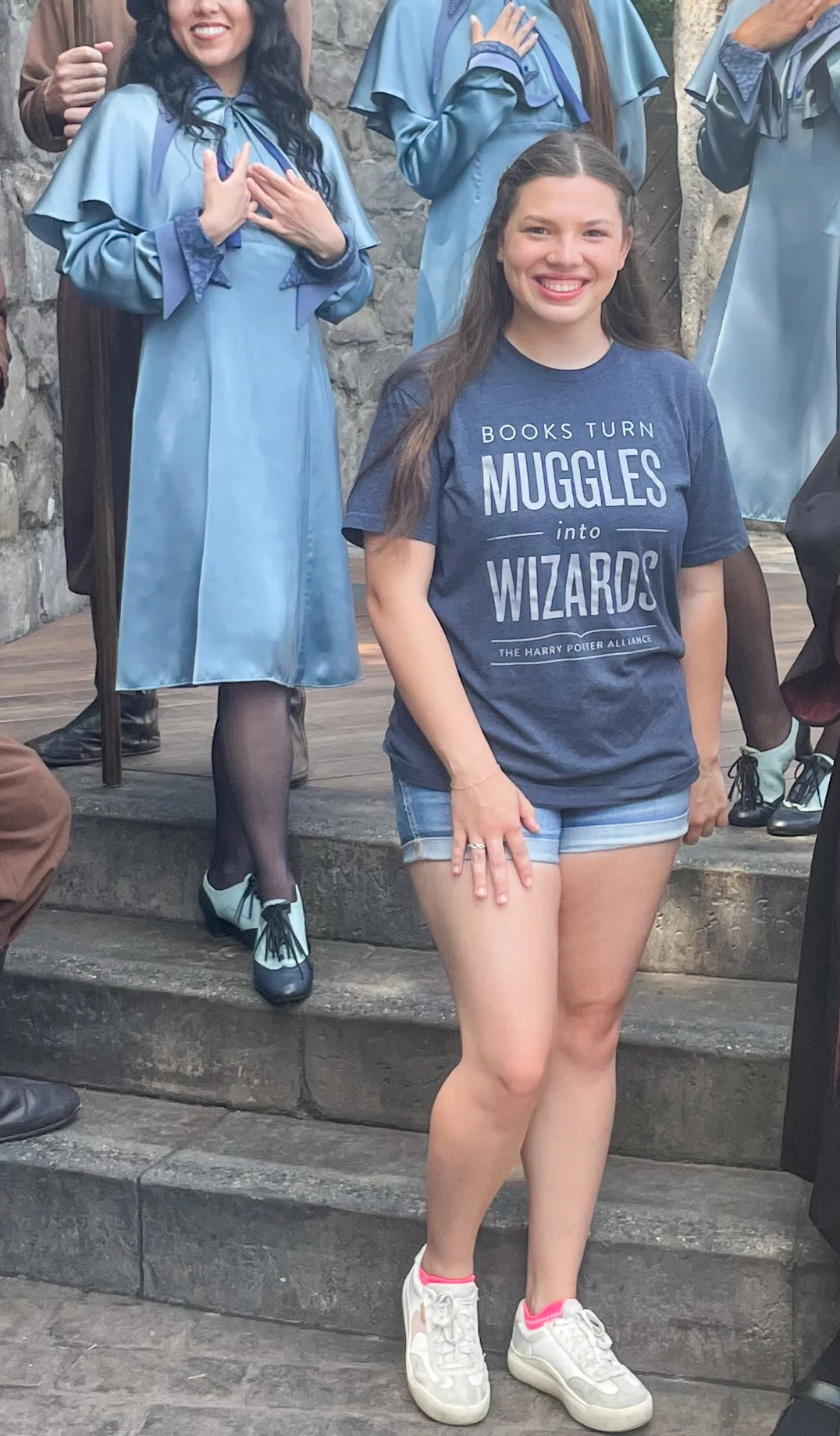 Girl smiling on steps at theme park