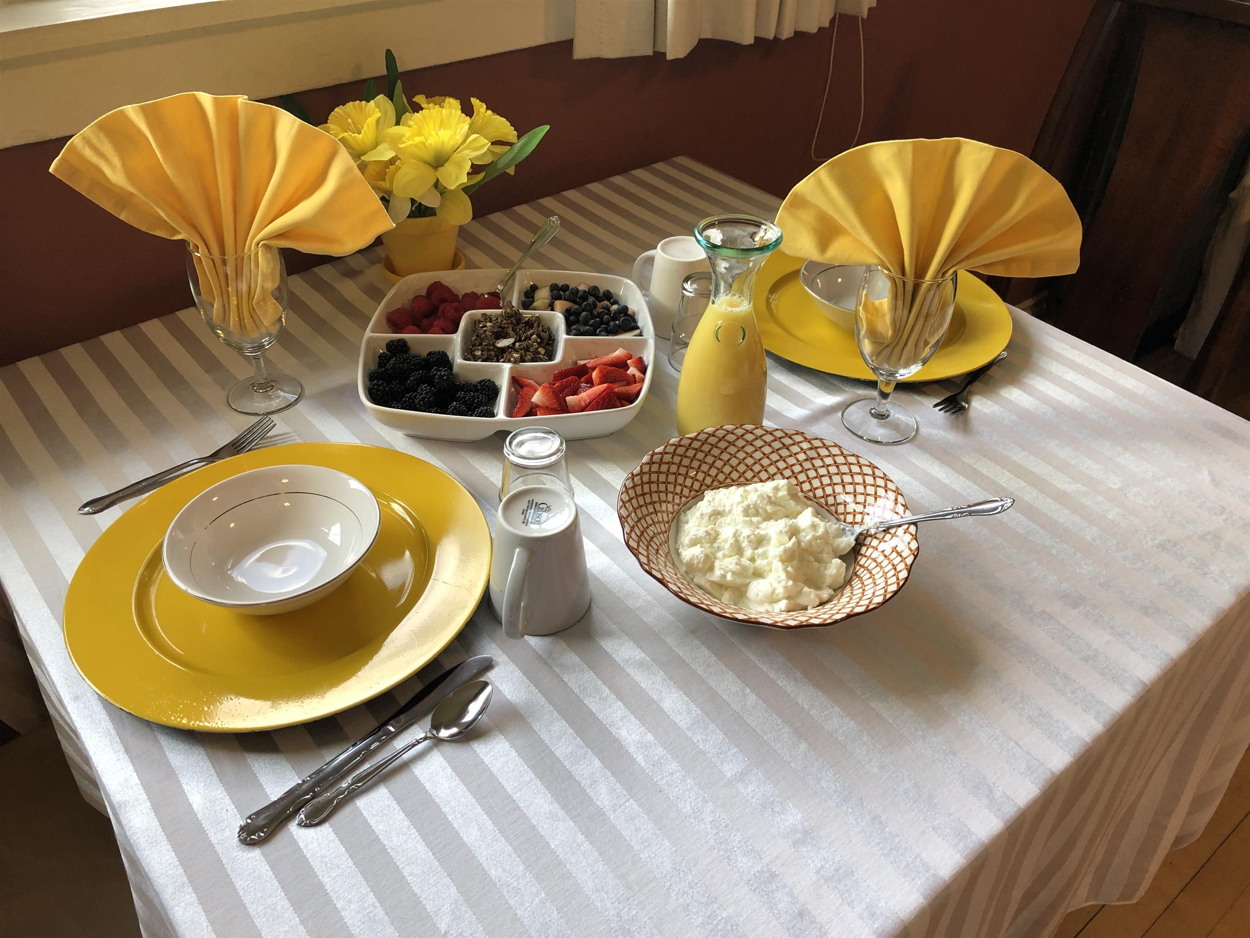 Table setting for two with yogurt and berry display